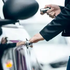 Mano abre la puerta del coche con la llave en la otra mano. La llave del coche gira pero no arranca.