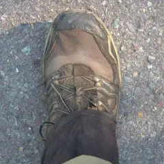 Dirty Gore-Tex hiking boot on gravel. Learn how to clean Gore-Tex shoes to keep them waterproof and ready for your next adventure.