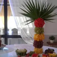 Kolorowa wieża z owoców: maliny, kiwi, pomarańcze, winogrona, ananas. Idealne jakie owoce do fontanny czekoladowej.