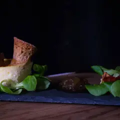 Delicato tortino di pecorino con confettura di fichi, crostino e insalatina fresca.