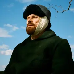 W filmie o van Goghu Willem Dafoe jako malarz z zabandażowanym uchem, w czapce i ciemnym płaszczu, patrzy w niebo.