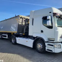 Biała ciężarówka Renault Premium z naczepą MEGA, gotowa do trasy.