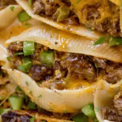 Close-up of cheesy, savory philly shell pasta stuffed with seasoned ground beef and green peppers, a delicious comfort food.