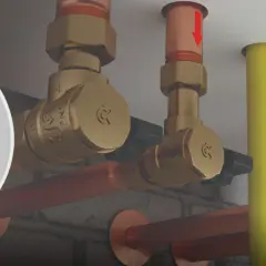 Zobacz, jak działa zawór zwrotny. Mosiężne elementy instalacji hydraulicznej, miedziane rury i żółty przewód.