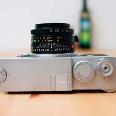 A silver Leica M10 camera with a black Leica Summicron lens attached, ready for capturing timeless moments.