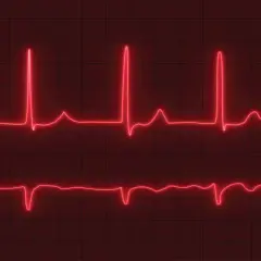 Dwa zapisy EKG na czerwonym tle. Górny zapis pokazuje szybkie, regularne skoki, sugerujące tachykardię zatokową. Dolny zapis jest wolniejszy.