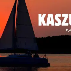 Żaglówka na jeziorze podczas zachodu słońca. Idealne miejsce na weekendowe wypady w **Kaszuby miejscowości turystyczne**.
