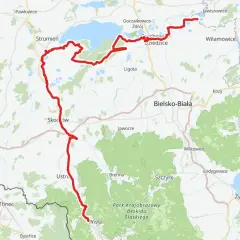 Mapa z zaznaczoną czerwoną trasą rowerową wzdłuż jeziora i terenów zielonych.