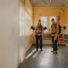 Para narciarzy w kurtkach z ociepliną **Primaloft co to** jest, czeka na pociąg.