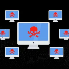 Komputery z czerwonymi czaszkami na ekranach, otaczające większy monitor. Symbolizuje to atak DDoS, gdzie wiele urządzeń jednocześnie próbuje przeciążyć cel.