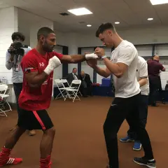 Boxers practice their moves, showing how to prepare for a fight. A cameraman films the training session.