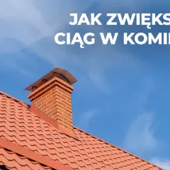 Ceglany komin na czerwonym dachu pod błękitnym niebem. Dowiedz się, jak poprawić ciąg w kominie, by ogrzewanie działało sprawniej.