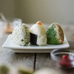 Three delicious rice balls with seaweed, seasoned and ready to eat.