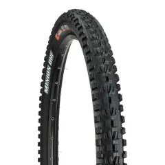A close-up of a Maxxis Minion DHF tire, ready for a downhill review. Its aggressive tread promises grip.