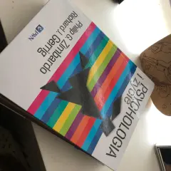 Na biurku leży książka "Psychologia" autorstwa Philipa G. Zimbardo i Richarda J. Gerriga, obok drewniane serce z rysunkami.
