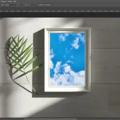 Ein Photoshop-Mockup mit einem weißen Rahmen, der einen blauen Himmel zeigt, daneben ein grünes Blatt.