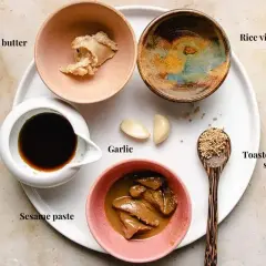 Ingredients for a delicious sesame sauce for hot pot: cashew butter, coco aminos, sesame paste, garlic, rice vinegar, and toasted sesame seeds.