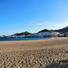 Playa de San José, con casas blancas en la ladera y el mar azul. ¡Qué carallo de vista!