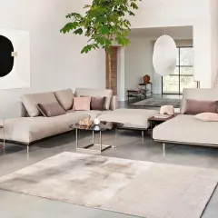 Modernes Wohnzimmer mit beigem Sofa, Kunst und Pflanzen. Tolle Wohnzimmer Ideen für ein stilvolles Zuhause.