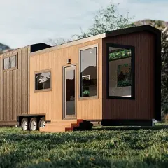 Tiny house sur roues dans un paysage verdoyant. La question "un particulier peut il acheter une maison en zone agricole" se pose face à ce type d'habitat.