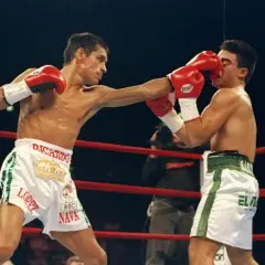 Ricardo "El Finito" Lopez lands a punch on his opponent during a boxing match.