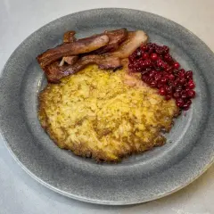 En gyllene raggmunk med knaperstekt bacon och rårörda lingon. Ett klassiskt raggmunk recept som smakar ljuvligt.