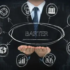 Biznesmen prezentuje koncepcję współpracy barterowej. Schemat pokazuje wymianę dóbr i usług, symbolizując korzyści dla partnerów.