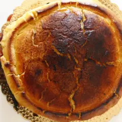 Crostata ricotta e visciole dorata, con la crosta leggermente bruciacchiata e un ripieno invitante.
