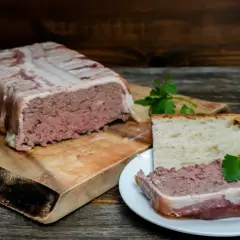 Pate zawinięte w boczek, pokrojone na talerzyku z chlebem. Pyszne pate, idealne na przekąskę.