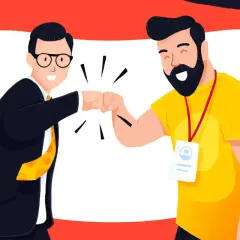 Dwóch mężczyzn w garniturze i żółtej koszulce wykonuje "fist bump" na tle czerwono-białym z żółtymi kołami.