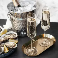 Austern mit Zitrone, Champagnergläser und Eis-Eimer mit Flasche.