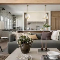 A living room and kitchen blend in Studio McGee's signature style: cozy, layered textures, natural materials, and a neutral palette.