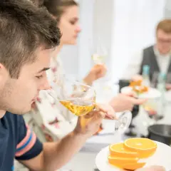 Teilnehmer einer WSET Kurse verkosten Wein und Orangen.