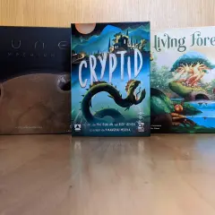 Drei Brettspiele: Dune: Imperium, Cryptid und Living Forest. Diese Spiele sind Kandidaten für den kritikerpreis spiel des jahres.