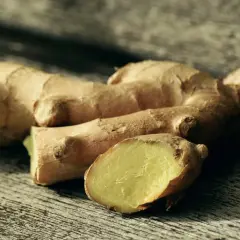 Raíces de jengibre fresco sobre madera, listas para explorar sus usos del jengibre en la cocina, aportando sabor y aroma a tus platos.