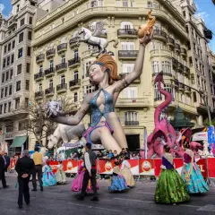 Gigantescas figuras de fantasía, como un dragón rosa y una mujer con un pegaso, dominan la calle en las Fallas 2026.