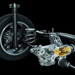 Przekładnia Haldex z widocznym mechanizmem napędowym, amortyzatorem i kołem samochodu.