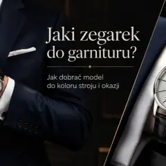 Elegancki mężczyzna w garniturze poprawia mankiet koszuli, prezentując klasyczny zegarek. Dowiedz się, jak nosić zegarek do koszuli, by dopełnić stylizację.