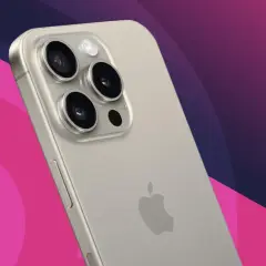Close-up of a silver iPhone's rear camera array with three lenses and a flash, against a pink and purple gradient background.