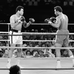 Muhammad Ali faces his opponent in the ring, a moment captured from one of his greatest fights.