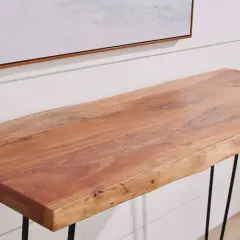 A live-edge acacia wood console table with black hairpin legs, showcasing the natural grain and warmth of the wood.
