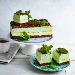 Orzeźwiające ciasto miętowe z mascarpone, udekorowane listkami mięty i czekoladą. Idealne na letnie popołudnie.