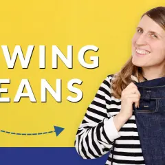 Woman smiles, holding up a pair of dark denim jeans, with "SEWING JEANS" text.