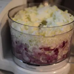En matberedare fylld med strimlad vitkål och rödlök, redo för en härlig tre veckors sallad.