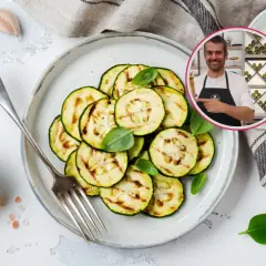 Rodajas de calabacín rallado a la parrilla, decoradas con albahaca fresca, junto a sal rosa y un chef sonriente.