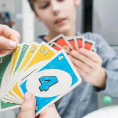 Dzieci grają w UNO. Jedno trzyma karty: zieloną czwórkę, żółtą szóstkę, zieloną siódemkę, żółtą siódemkę i niebieską czwórkę. Czy można kłaść kilka kart?