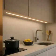 Ambiente acogedor en dormitorio y cocina con iluminación led. Un hombre instala una tira led en el techo.