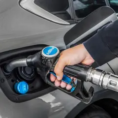 Persona repostando AdBlue en su coche. La cantidad de kilómetros que dura el AdBlue varía según el vehículo y el estilo de conducción.