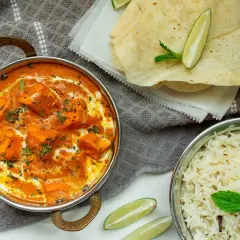 Un cremoso plato de paneer tikka masala, que es el curry, acompañado de arroz basmati y pan naan.
