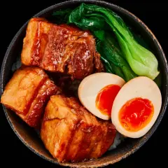 A bowl of Japanese pork belly with rice, bok choy, and a soft-boiled egg.